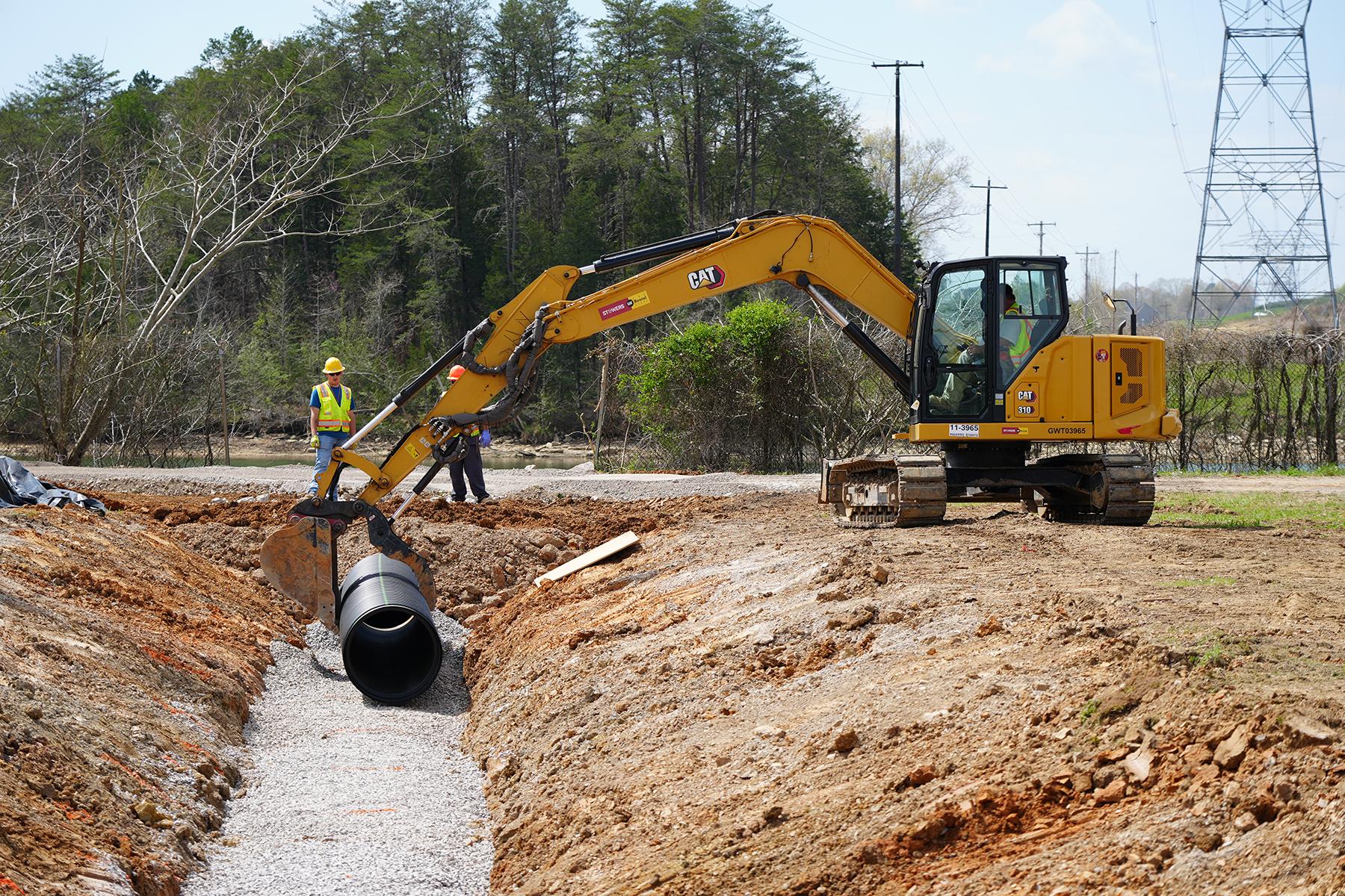 Crews at Heritage Center replace stormwater piping