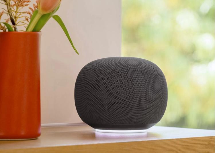 google home smart speaker on a shelf with a vase of flowers