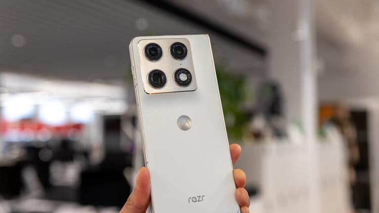 motorola razr fold held in hand in modern office