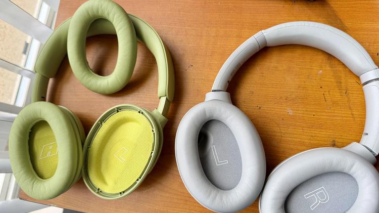 sony and bose headphones facing up, with one ear cushion popped out of Bose headphones