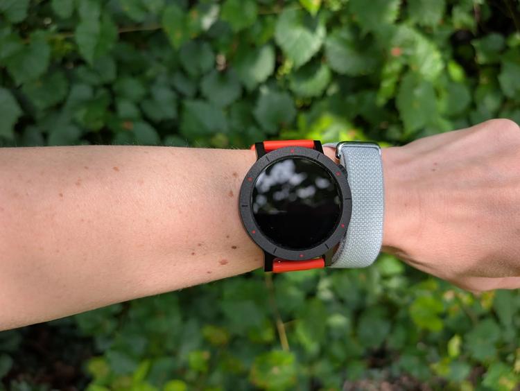 the google fitbit air on a wrist next to the cmf nothing watch 3 pro