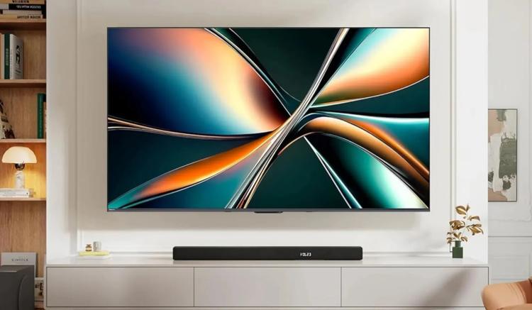 Hisense U6 Pro TV mounted on wall above soundbar and TV stand