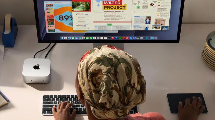woman using mac mini and apple studio display