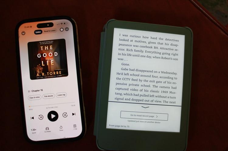 audible app on phone laying next to kindle device