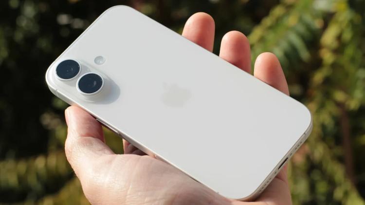 a man's hand holding the iphone 17
