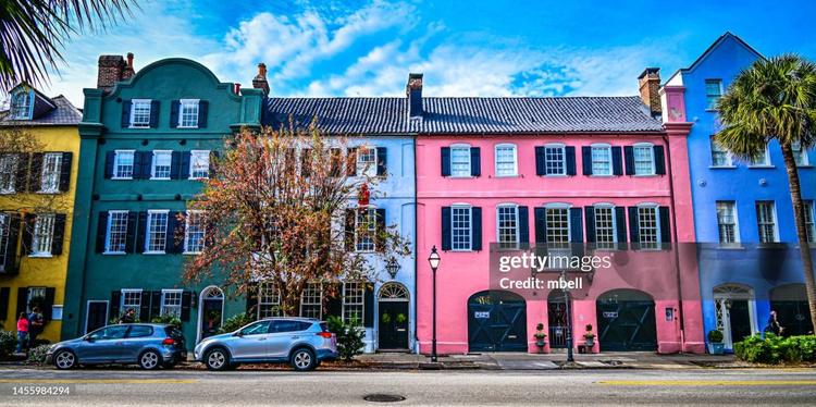 Rainbow Row on East Bay Street in Charleston, South Carolina, features 13 pastel-colored historic homes. Their vibrant look traces back to a Colonial Caribbean color inspiration chosen during 1930s restorations by resident Dorothy Porcher Legge, who drew from West Indian building styles to revitalize the neglected waterfront block.