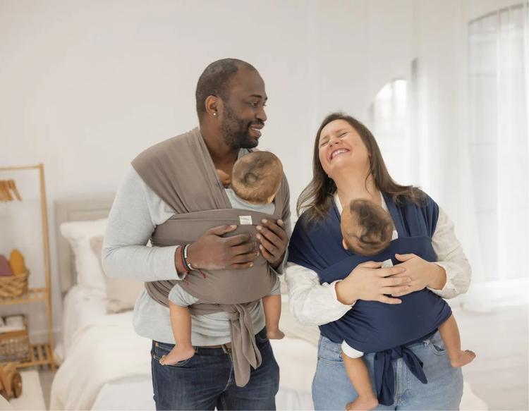 Parents babywearing while enjoying slow, quality time with their baby.
