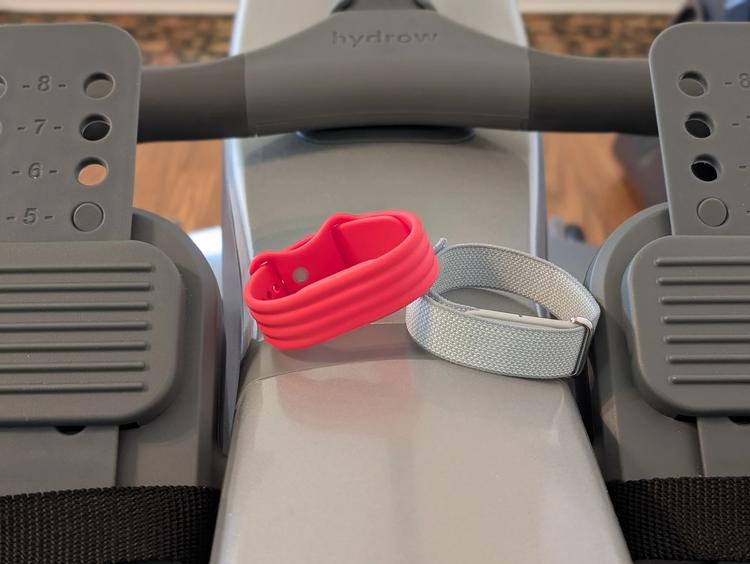 the fitbit air sits on a rowing machine