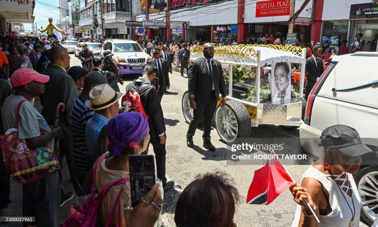 Fans of the singer Mighty Sparrow line the street during a funeral procession in Port of Spain on October 16, 2026. A huge caravan brought hundreds of Trinidadians together on Friday to bid farewell with music and merrymaking to Mighty Sparrow, the legendary singer-songwriter who died in September and who brought calypso from the Caribbean island to the rest of the world.