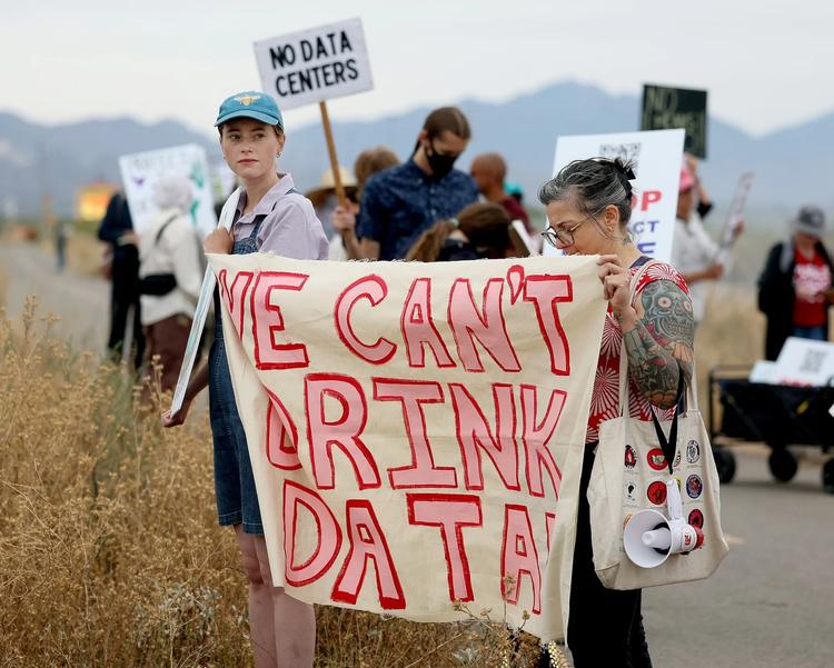 Demonstrators hold signs during a protest against the Project Blue data center in Tucson, Arizona