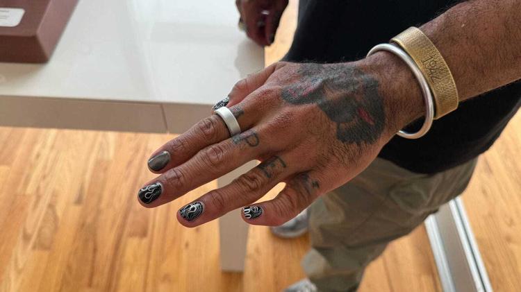 the oura ring 4 on a tattooed hand