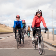 Cyclists riding along seaside promenade