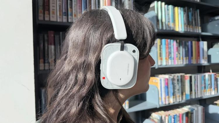 a woman wearing the nothing headphone (a)