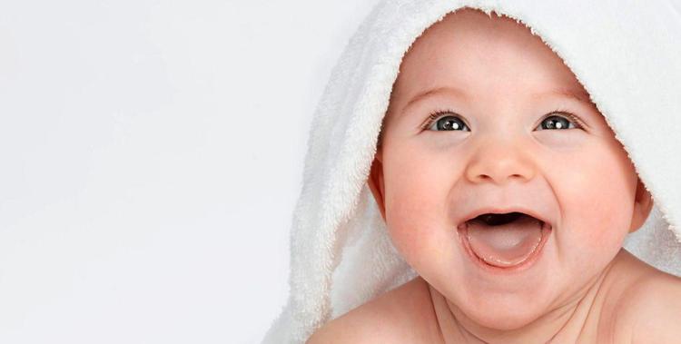  Baby mit einem Kapuzenhandtuch auf dem Kopf