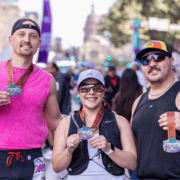 Three members of a running crew stand together after a race, wearing medals that say “35 Years” and “Austin Half Marathon.” Austin Marathon Half Marathon & 5K