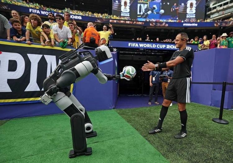 Atlas hands off the match ball to the ref at the half.