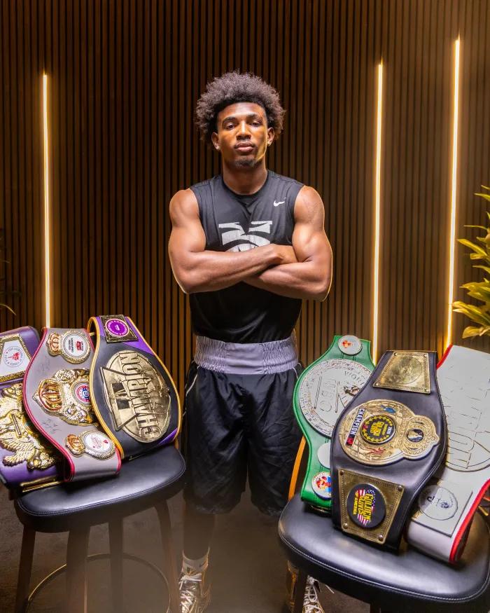 “It has given me a home within a home,”Morehouse College junior Emmanuel Seifu shows off his title belts.
