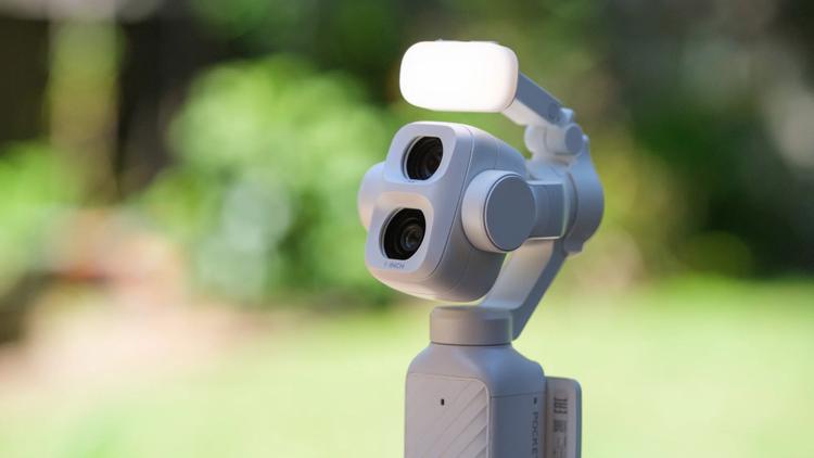 The DJI Osmo Pocket 4P in Pearl White with the Fill Light accessory attached.