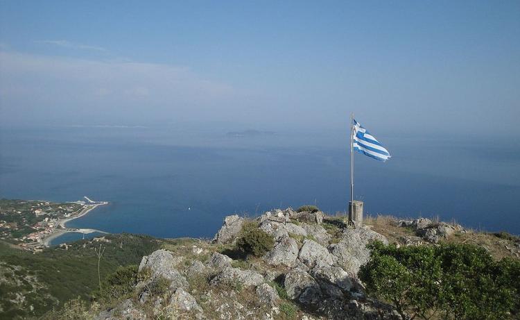 Imerovigli , highest point of othonoi island, has a greek flag on top