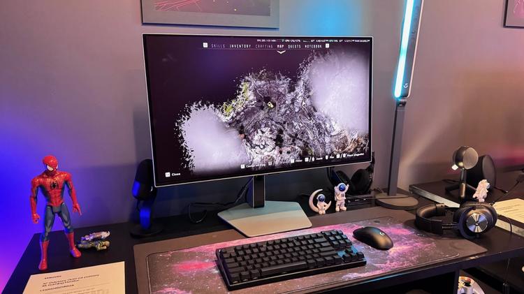 the Samsung oled g8 monitor on a desktop with keyboard and other accessories.