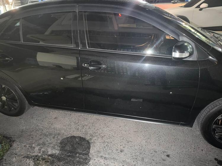 Bullet holes on a car said to belong to the Guyana Opposition Leader