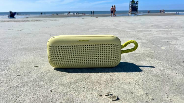 yellow bose soundlink speaker on the beach