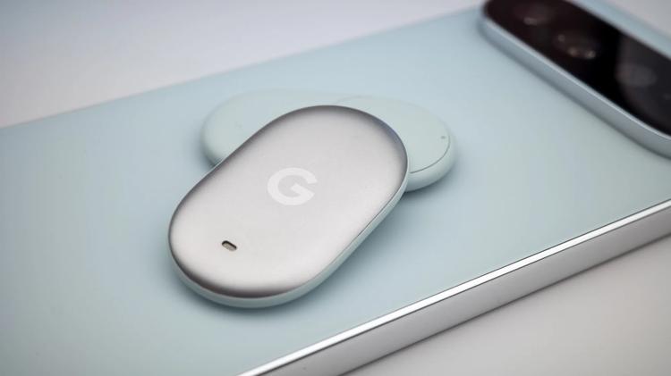 Silver Pixel Tag tracker lays against green phone