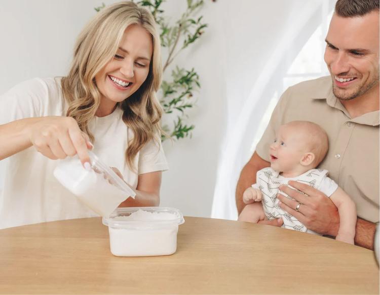 Mom and dad bonding with baby while casting hands using the KeaBabies Reve Baby Casting Kit.